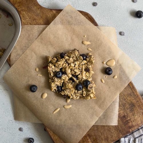 Ein Stück Haferflockenauflauf (Baked Oats) auf einem Holzbrett