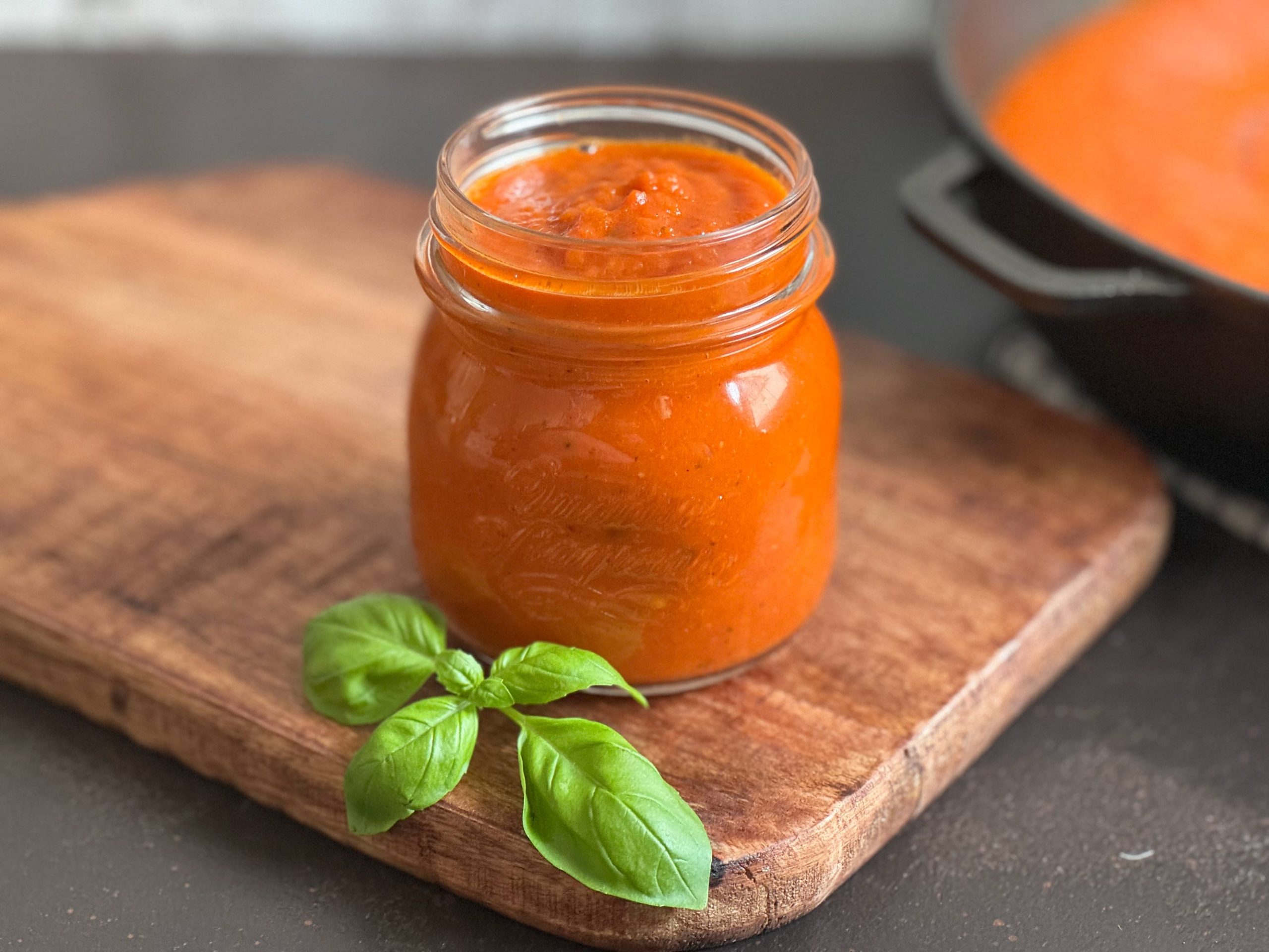 Wuerzige Tomatensauce im Glas mit Basilikum